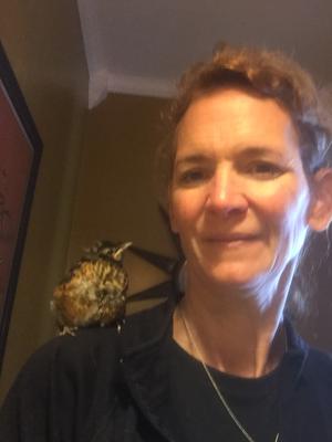 baby robin on womans shoulder