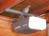 adult dove perched on garage door opener motor housing support bracket